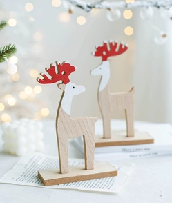Macro detail of wooden reindeer figurines with red spotted antlers for festive decor