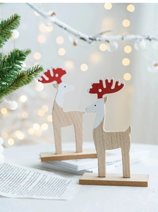 Detailed view of handcrafted wooden reindeer ornaments with white and red accents