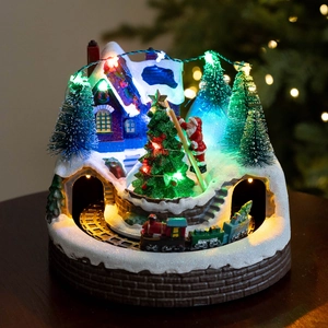 Luminous Christmas music box with rotating tree, Santa, and train on red brick base