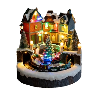 Lighted Christmas village scene with rotating train, snowy European houses and LED lights