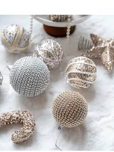 Detailed close-up of champagne gold sequined and rhinestone luxury Christmas ornaments