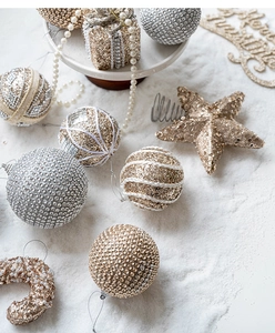 Detailed view of champagne gold Christmas ornaments with rhinestones and faux pearls