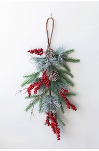 Detail of Christmas swag with pine needles, red berries, pine cones and jute rope loop