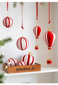 Close-up of red and white velvet Christmas hot air balloon ornaments with glitter details