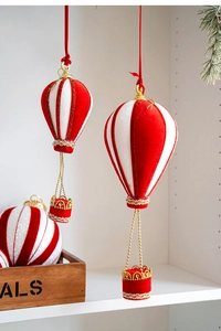 Detail of red and white striped hot air balloon Christmas ornament with gold crown basket