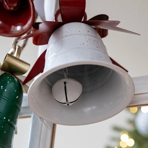 White metal Christmas bell ornament with red bow and gold speckles for festive decor