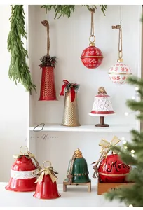 Detailed view of red and gold Christmas iron bells with snowflake patterns and bows
