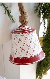 Close-up of vintage red and white checkered iron bell with rustic jute rope for Christmas