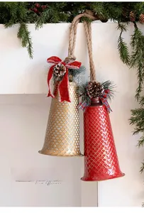 Close-up of metal Christmas bells with rustic twine, pine cones and festive bows