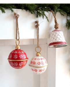 Vintage metal Christmas bell ornaments with snowflake patterns and rustic jute rope