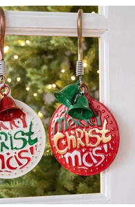 Close-up of vintage metal Merry Christmas door signs with bells and rustic hooks