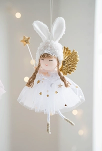 Detail of angel rabbit doll with golden wings, white mesh skirt, and star wand ornament