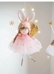 Detail of pink angel rabbit plush ornament with golden wings and lace skirt for Christmas