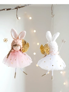 Detail of plush angel rabbit hanging ornaments with sparkly gold wings and mesh skirts