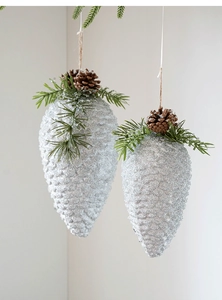 Detail of silver glitter pine cone ornaments with natural pine needles and hemp rope