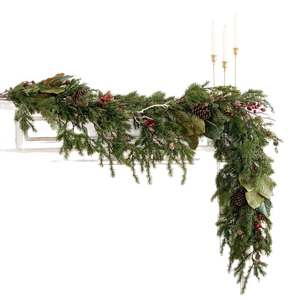 Forest-style Christmas garland with pine cones and red berries on a white fireplace