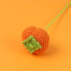 Handmade crochet persimmon branch decor with vivid orange fruit and green leaves