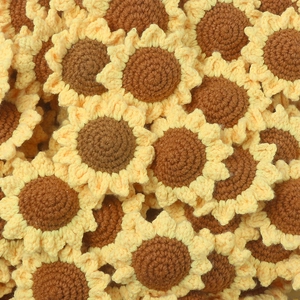 Close-up of handmade crochet sunflower keychain with vibrant yellow petals and brown center