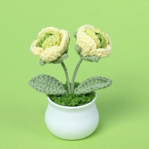 Handmade crochet potted plant featuring two soft yellow flowers in a white ceramic vase