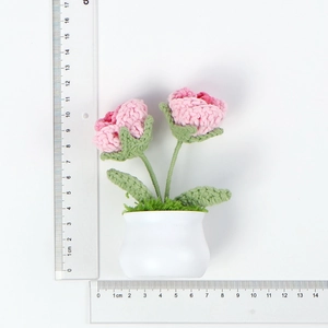 Detail view of handmade crochet pink rose potted plant measuring 11cm in height
