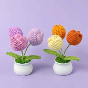 Detail von handgehäkelten Tulpen-Topfpflanzen mit lila und gelben Strickstrukturen