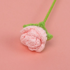 Close-up of handmade pink crochet bubble rose showing delicate wool texture and layers