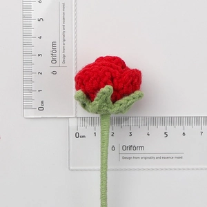 Handmade crochet red rose flower bouquet with dimensions shown on a ruler