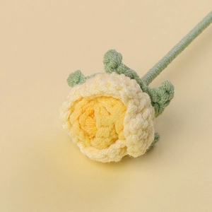 Detail of a handmade crochet bubble rose bouquet with creamy white and yellow yarn