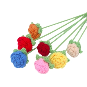 Handmade crochet bouquet with seven colorful knit roses on a clean white background