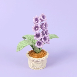 Handmade crochet lily of the valley potted plant with purple flowers and pearl details