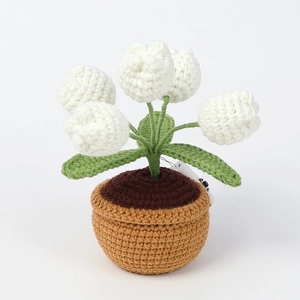 Handmade crochet lily of the valley potted plant with five white flowers on white background