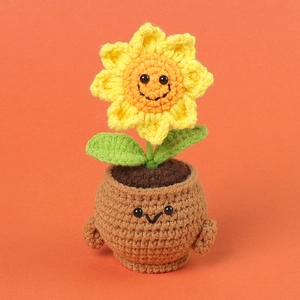 Handmade crochet sunflower potted plant with cute smiley face emoji for home decoration