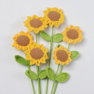 Detail of six handmade crochet sunflowers with yellow petals and brown centers