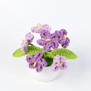 Handmade crochet potted hydrangea plant with purple flowers and green leaves on white background