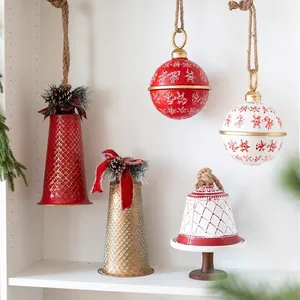 Festive iron Christmas bells and ball ornaments with snowflakes and checkered patterns