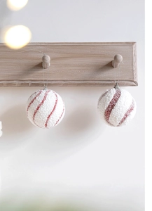 Close-up of 8cm red and white spiral glitter Christmas balls hanging on a wooden rack