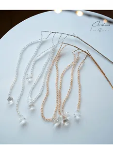 Close-up of clear acrylic beaded chain with teardrop pendant for Christmas tree decor