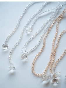 Detailed macro view of faceted clear and champagne acrylic crystal bead strands
