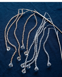 Close-up of faceted acrylic crystal beads and pear-shaped drop pendants for Christmas decor