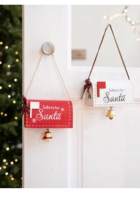 Detail of red and white wooden mailbox ornaments with letters for Santa and golden bells