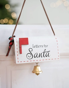 Detail of white wooden Letters for Santa mailbox ornament with red bow and gold bell