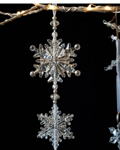 Macro view of transparent acrylic snowflakes with silver glitter for Christmas tree decor