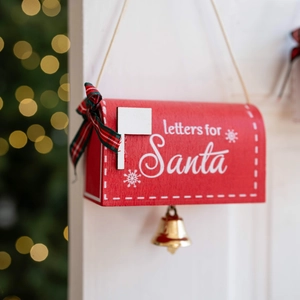 Red wooden Santa mailbox ornament with green plaid bow and golden bell decoration