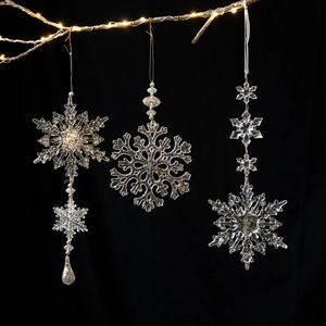 Set of clear acrylic snowflake ornaments for Christmas tree with warm fairy lights