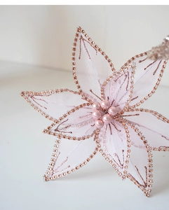 Detail of pink mesh Christmas flower with rose gold rhinestones and pearls