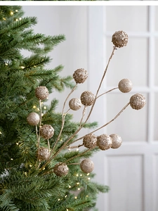 Close-up of champagne gold glitter berry stems for Christmas tree and home decor