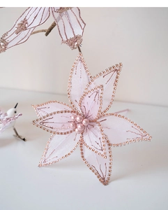 Detail of pink tulle Christmas flower with champagne sequins and center pearls