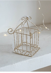 Détail d'ornement de Noël cage dorée pailletée avec ruban sur fond de fête scintillant