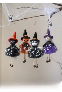 Detail of four Halloween dolls with tulle skirts and metal bells for party decor