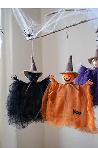 Detail of Halloween ghost and pumpkin mesh pendants hanging on spooky tree branches